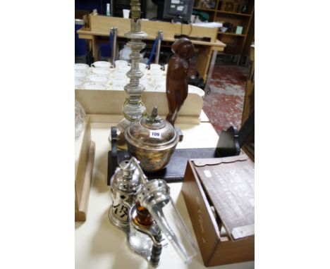 A copper and gilt cup and cover in the 18th Century style, an altar candlestick, a bookrack, a carved wood figure and a Japan