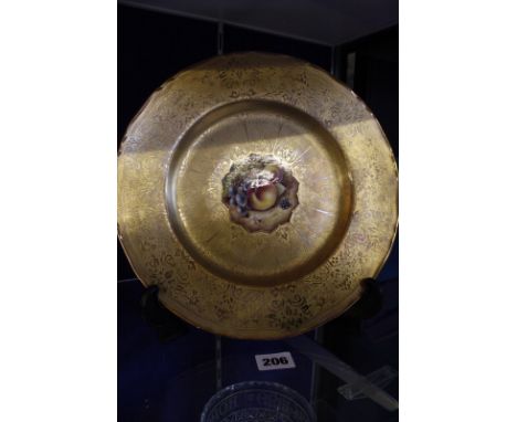 A Royal Worcester cabinet plate, with gilt decoration and hand painted fruit to the centre, signed T. Nutt, 27.5cm in diamete