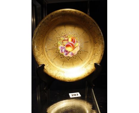 A Royal Worcester cabinet bowl, gilt decorated with hand painted fruit to the centre, signed D. Shinnie, 23cm in diameter