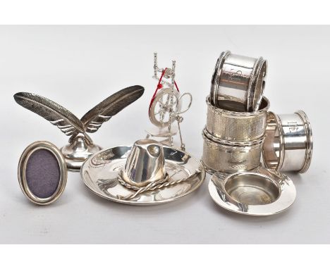 A COLLECTION OF SILVER AND WHITE METAL ITEMS, to include four hallmarked silver napkin rings, two of which have an engine tur