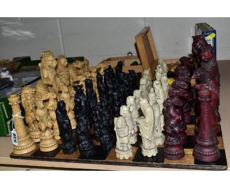 A WOODEN CHESS BOARD AND A QUANTITY OF WOODEN AND RESIN CHESS SETS, including two resin sets formed of Oriental figures and a