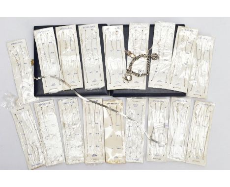 A SELECTION OF PACKAGED CHAINS, FLAT HERINGBONE CHAIN AND A CHARM BRACELET, the bracelet with four charms to include a stampe
