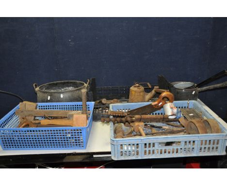 THREE TRAYS CONTAINING VINTAGE TOOLS AND METALWARE including an oval Cauldron, saucepans, cast iron pulleys and wheels, bits,