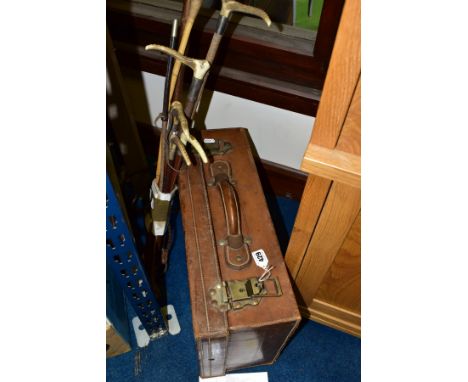 A VINTAGE BROWN LEATHER SUITCASE WITH KEY, the two metal clasps stamped '?Boobakr H? Karachi 6 Lever', blue fabric lined inte
