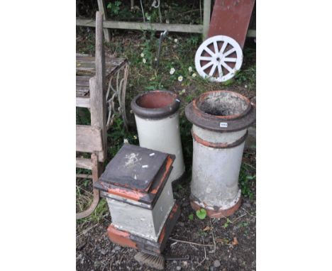 THREE VINTAGE CHIMNEY POTS two circular in profile 70cm and 64cm in height and a smaller square section pot (3) (SD and losse