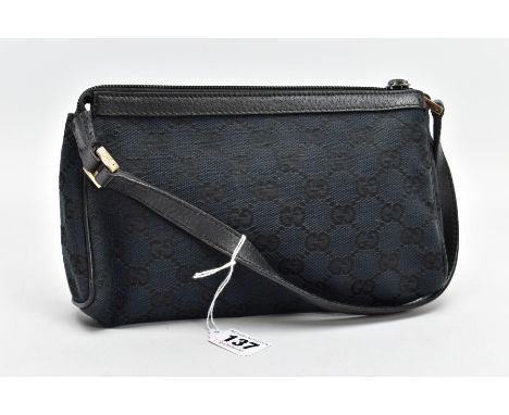 A SMALL BLACK GUCCI BAG, the monogram canvas with brass fittings and zip closure, inner label stamped Made In Italy, measurin