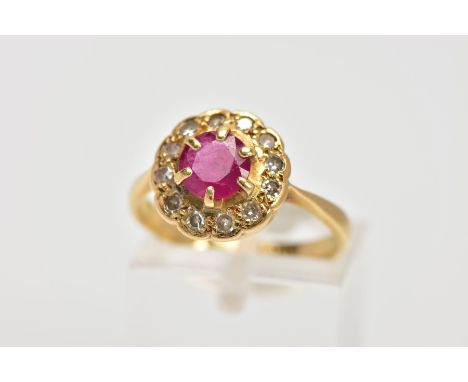 A YELLOW METAL RUBY AND DIAMOND CLUSTER RING, designed with a central claw set circular cut ruby, within a single cut diamond