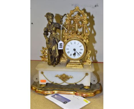 A MID/LATE 19TH CENTURY GILT METAL AND ALABASTER FIGURAL MANTEL CLOCK, the drum shaped clock with surmounts of arched window,