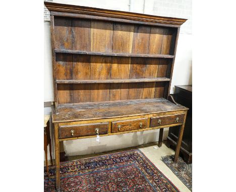 A George III oak dresser, with two shelf rack and three long drawers, on chamfered legs, width 167cm, depth 49cm, height 193c