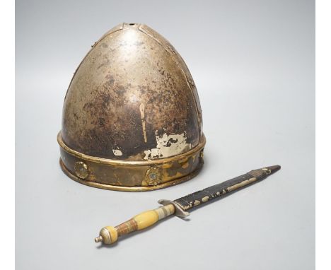 A Middle-Eastern silvered metal and brass helmet and a dagger in sheath