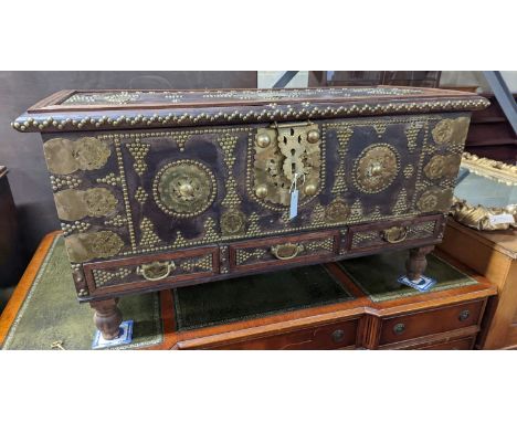 An Eastern brass mounted and studded hardwood trunk, length 113cm, depth 48cm, height 60cm