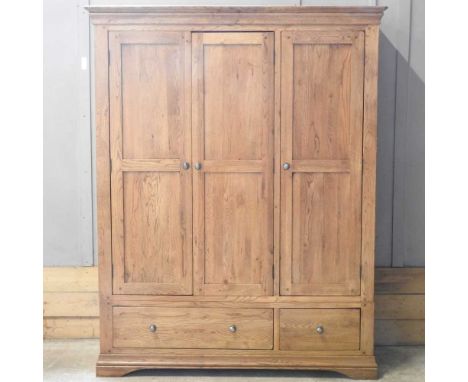 A modern light oak triple wardrobe, with drawers below150w x 64d x 192h cm