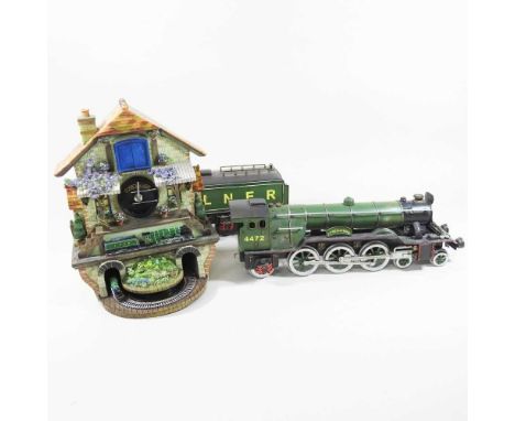 A Bradford Memories of Steam Flying Scotsman cuckoo clock, 33cm high, boxed as new, together with a large tinplate model Flyi