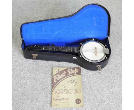A British Made eight string banjo mandolin, 55cm long, in a hard case, together with a book (2)
