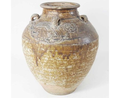 A Chinese earthenware urn or storage jar, of bulbous shape, with ring handles and raised dragon decoration, 41cm high