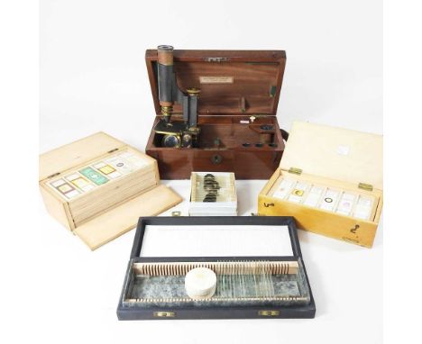 An early 20th century microscope, with lenses, in a fitted mahogany case, label for Millikin &amp; Lawley, 165 The Strand, 30