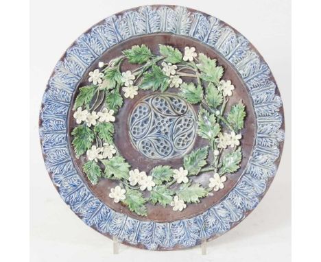 A Castle Hedingham pottery dish, decorated in relief with flowers, signed, 28cm diameterOverall condition is complete, but di