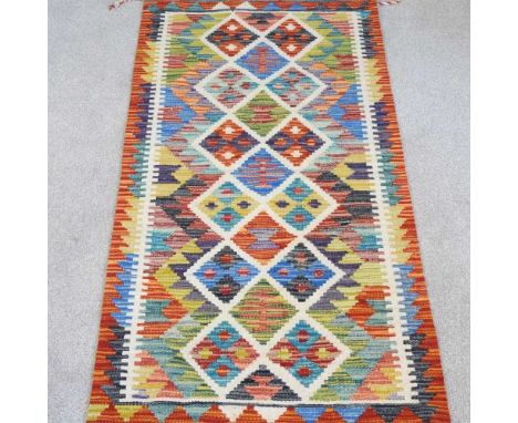 A kilim runner, with rows of coloured diamonds, 140 x 65cm