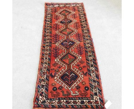 A Persian lori runner, with a central row of hooked medallions, 210 x 78cm