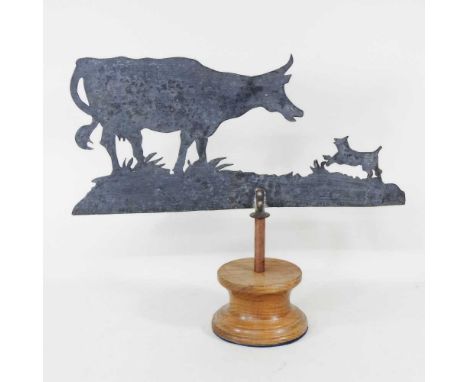 A metal weather vane in the shape of a cow and a dog, inscribed "Made from a German plane shot down over Kent", 40 x 47cm