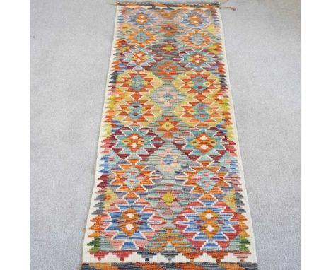 A kilim runner, with all over coloured medallions, 200 x 63cm