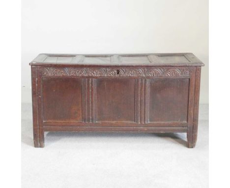 An 18th century carved oak coffer, with a hinged lid and carved decoration138w x 56d x 70h cm