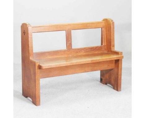 A light oak settle, in the style of Robert "Mouseman" Thompson, carved with a mouse107w x 42d x 80h cmOverall condition is co