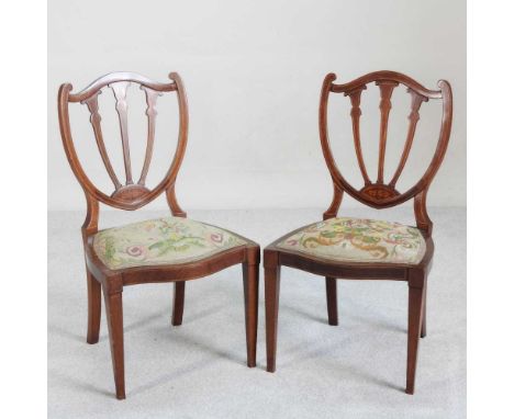 A pair of Edwardian mahogany and inlaid shield back side chairs, with tapestry seats (2)