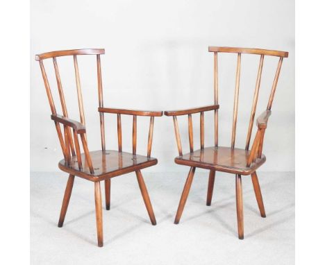 A pair of hardwood comb back armchairs, on splayed legs (2)