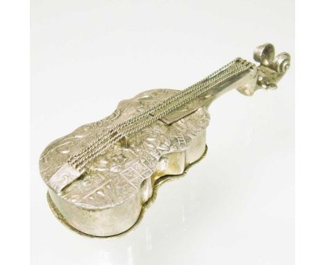 A Dutch metalwares novelty pill box, in the form of a cello, with a hinged lid and repoussé decoration, 13cm long