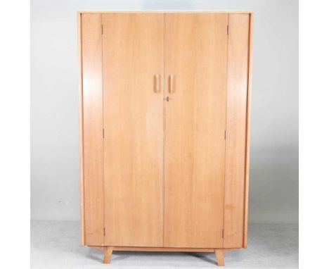A mid 20th century walnut double wardrobe, on tapered legs122w 53d x 184h cm