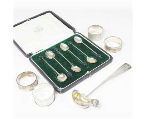 A set of six early 20th century silver coffee spoons, with bean terminals, cased, together with a continental silver ladle an
