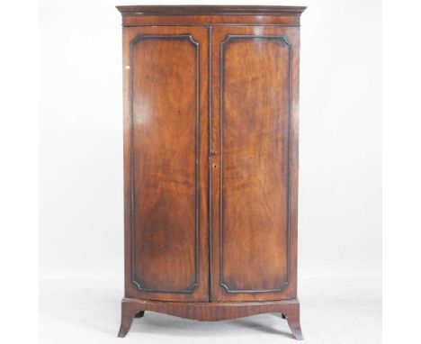 A 1930s bow front double wardrobe, on swept bracket feet107w x 54d x 189h cm