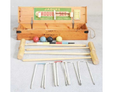 A Jaques croquet set, in a wooden caseHas six hoops, four mallets and four balls. Overall condition is sound, but used.