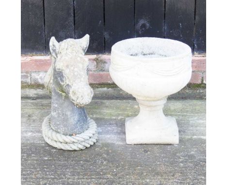 A cast stone garden urn, together with a head of a horse, 50cm high (2) 