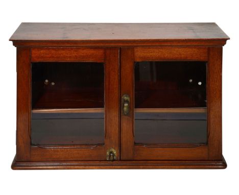 RMS Olympic Interest. A mahogany glazed wall cabinet c.1910projecting moulded cornice over a pair of glazed doors enclosing a