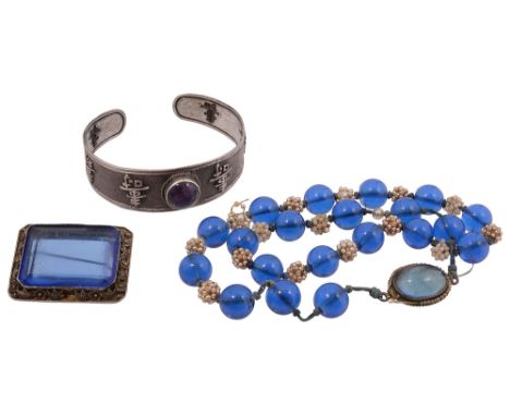 A Chinese amethyst and silver open cuff and Peking glass jewellery early 20th centuryfirst set with a raised rub over set ame