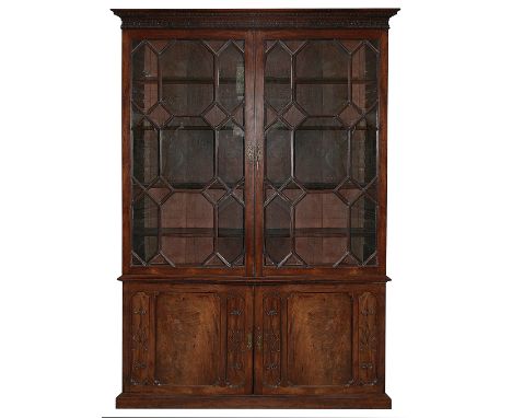 A George III mahogany bookcase cabinetcirca 1760of one piece, the dentil cut cornice above a blind fret frieze, the pair of g