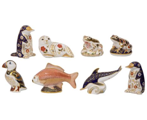 A collection of eight Royal Crown Derby paperweightsincluding a pair of Platapuses, a Puffin, a Seal pup, a Red Fish, a Dolph