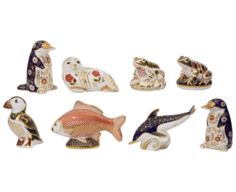 A collection of eight Royal Crown Derby paperweightsincluding a pair of Platapuses, a Puffin, a Seal pup, a Red Fish, a Dolph