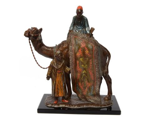 An Austrian cold painted spelter 'The Carpet Trader' table / cigar lighter in the manner of Bergmann  cast as an Arabian carp