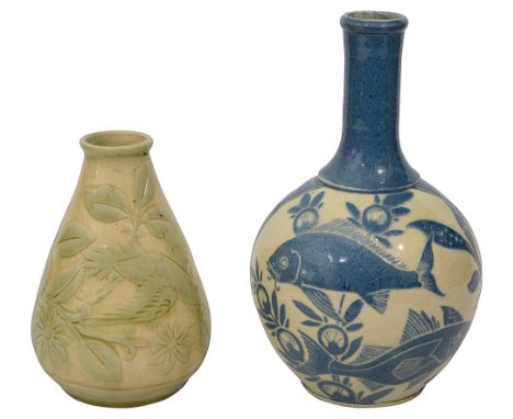 A C.H. Brannam pottery vase and another Brannam exampleof bottle form and on a cream and pale blue ground with two panels wit