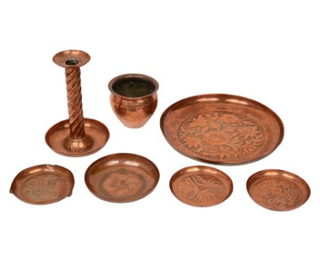 Keswick School of Industrial Art. Arts and Crafts repousse decorated hammered copper dishes, a candlestick and a cache potcom