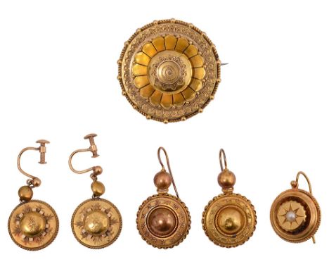 Various items of mid Victorian yellow gold Etruscan Revival jewellery: the circular locket brooch with applied decoration, an
