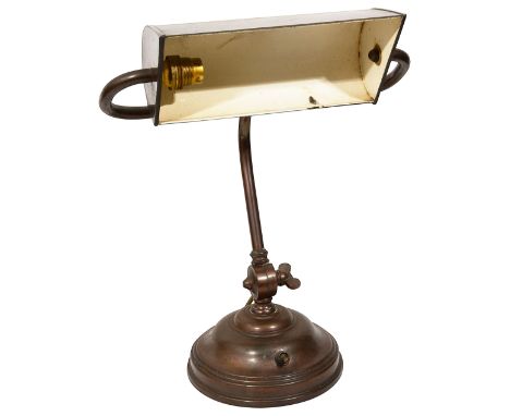 A 1920s/30s copper banker's lampwith a wedge form adjustable shade, the adjustable shaped stem on a domed circular baseheight