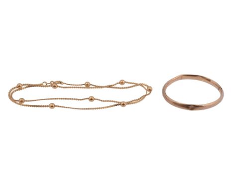 A 18ct flexible fancy link flattened chainmarked '750' to the clasp, decorated with nine spheres together with an baby's hing