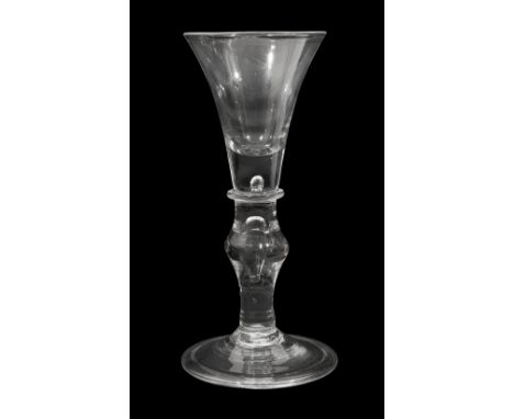 A mid 18th century light baluster wine glass c.1740drawn trumpet bowl with solid base enclosing a small tear on a basal colla