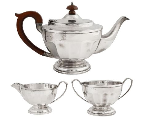 A George V silver three piece tea serviceBirmingham, 1930, Syner &amp; Beddoesof circular panelled tapering form on a domed f