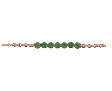 A flexible link jadeite bracelet, the middle section composed of seven articulated circular engraved jadeite discs, closed ba