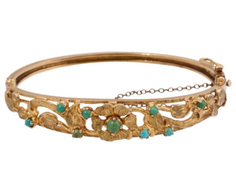 A 9ct yellow gold hinged and turquoise-set  banglethe tapering top section of textured floral and foliate openwork design wit